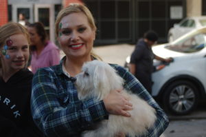 Amanda holds a dog at an event.