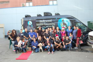 The Hollywood Grooming team sit in front of a company van.